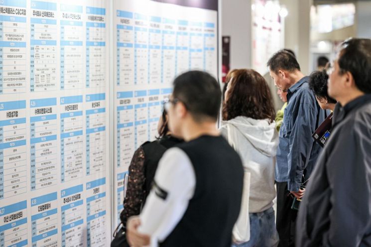 14일 용인미르스타디움에서 열린 일자리박람회에서 구직자들이 채용공고를 보고 있다. 용인시 제공