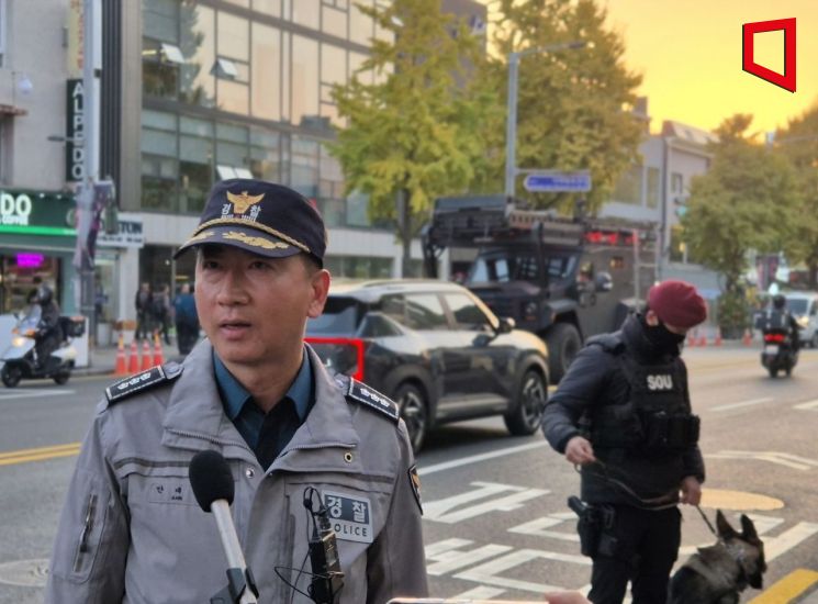 안대선 서울 용산경찰서 경비과장이 30일 오후 이태원역 1번 출구 앞에서 기자들과 만나 인파 관리 대책을 설명하고 있다. 안 과장 뒤로는 경찰 장갑차가 배치돼있다.