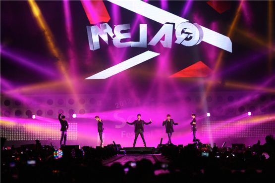 MBLAQ members Mir (left), Seung-ho (second to left), G.O. (center), Lee Joon (second to right) and  Cheon-dung (right) perform under flamboyant spotlights at the 2012 Asia Song Festival held during The Expo 2012 Yeosu Korea in Jeolla Province August 4, 2012. [KOFICE]