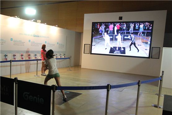 A girl is dancing with Super Junior's Lee Teuk and Eunhyuk in screen at "Genie with KT" booth during the preview session of SM Entertainment's S.M.ART EXHIBITION held at the COEX Mall in Seoul on August 9, 2012. [Lee Ki-won/10Asia] 