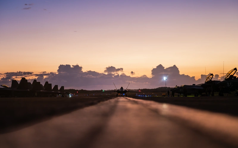 A US Air Force F-22 Raptor fighter jet is taxiing along the runway following a military operation conducted in Venezuela in support of 'Operation Absolute Resolve.' The F-22 is the US Air Force's primary air superiority fighter responsible for gaining control of the airspace.